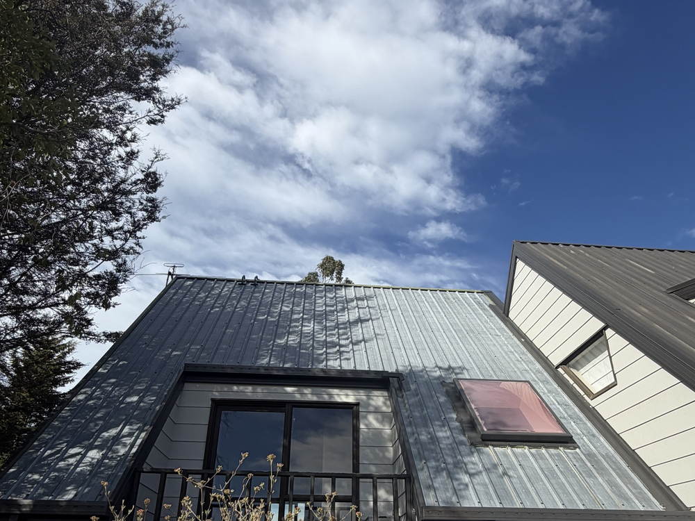 The same Kaiapoi house before painting, the long-run roof faded and chalky grey